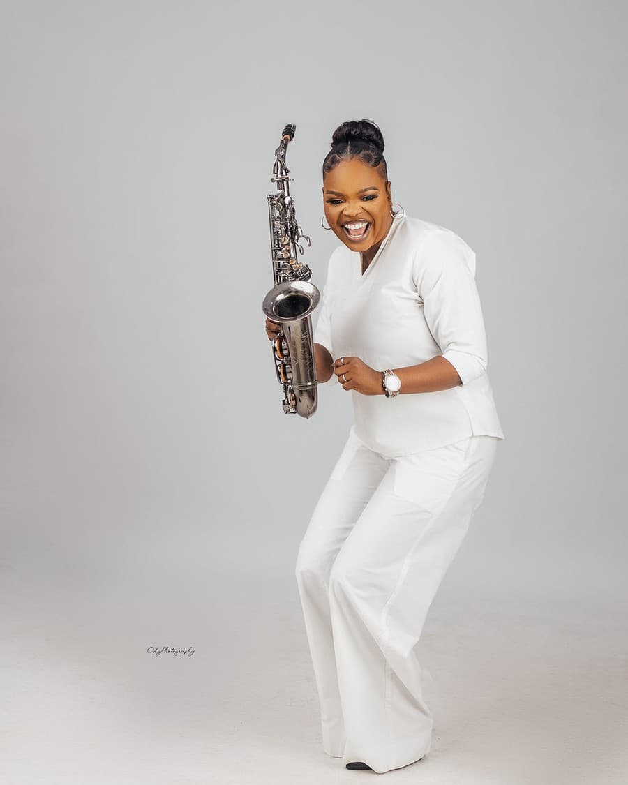 Funmisax playing in white outfit